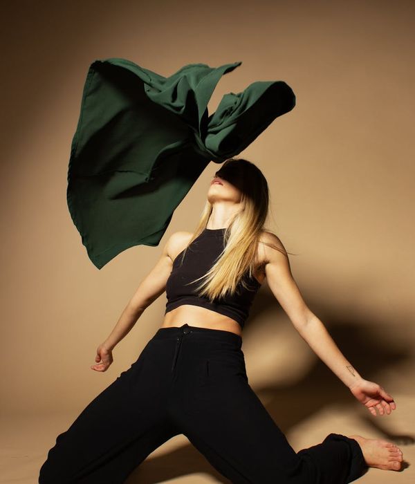 Woman in a dynamic yet graceful pose, representing energy and fluidity.